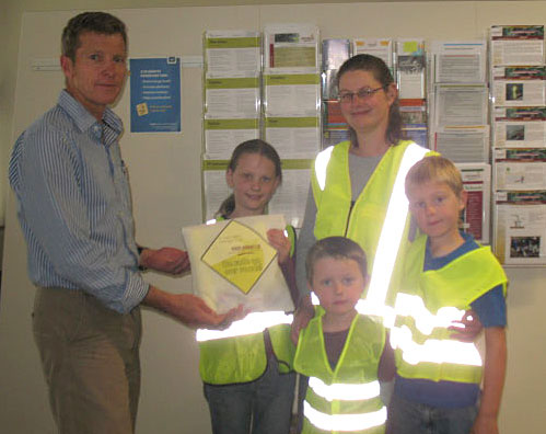 The Kirk family from Renwick receiving their prizes of high-visibility reflector cycling vests from Council 