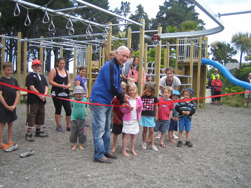 Councillor Peter Jerram does the honours at the official opening of the new children's playground at Rarangi last weekend.