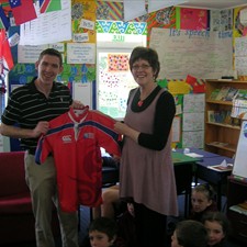 George Clancy presents his jersey to deputy principal Margaret Jones