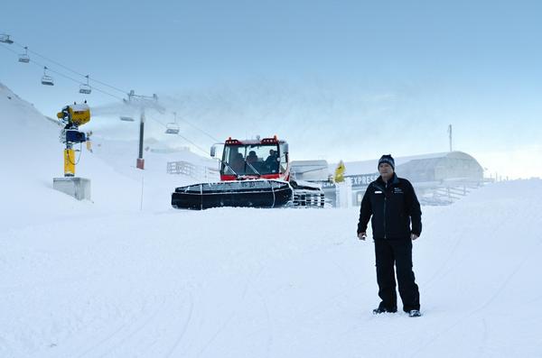 Coronet Peak Ski Area Manager Hamish McCrostie pictured with a snow gun blazing and groomer operating in preparation for opening this Saturday (June 9).