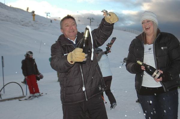 Corks popping - Coronet Peak Ski Area Manager Hamish McCrostie and Amisfield Winery Sales Executive Olivia Herbert.