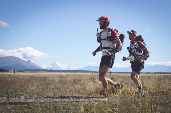 Winners of Team Race last year, Alexandre Lucas and Vincent Hulin of France running through the Mackenzie district with Mt Cook in the background