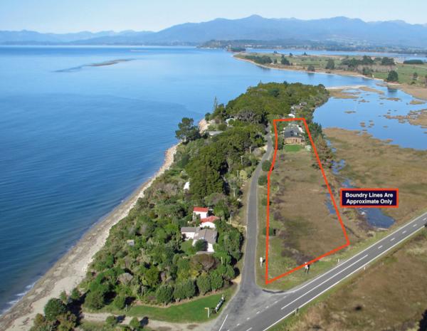 Lodge for sale beside tidal estuary and metres from stunning beach in the Nelson region of New Zealand. Excellent home and income opportunity!