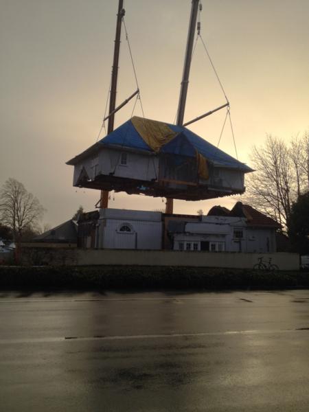 House being lifted into position after being moved following EQs