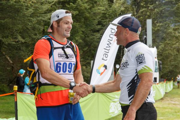Richie McCaw is welcomed at the finish of the Coast to Coast mountain run by Kathmandu Coast to Coast nine time winner and ambassador Steve Gurney. 