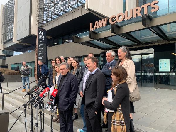 Gloriavale plaintiffs and legal team on the steps of the Employment Court after July 2023 decision