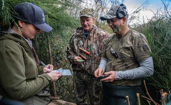 Fish & Game officer Emily Craig checks the game bird hunting licences of Gary Boyce, middle, and Roger Broomhall near the Waimakariri Gorge.