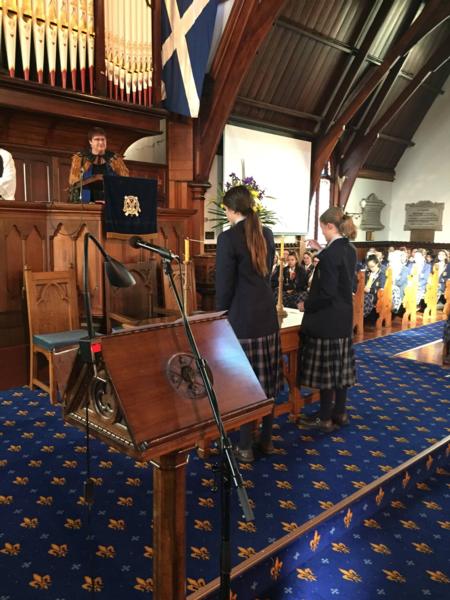 Direct descendants of the original Gibson Sisters student's Olivia and Evie,  light the candles during the Founders Day service.