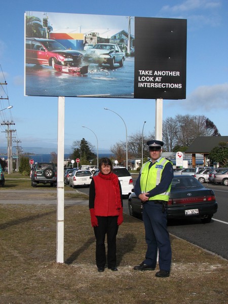 Council�s Road Safety Coordinator Christine Hutchison and Senior Sergeant Murray Hamilton in front of one of the billboards which urge motorists to take extra care at intersections.