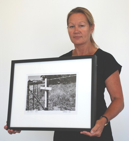 Papakura road safety co-ordinator Donna Dick with an image from the first exhibition of 2008, Crossroads