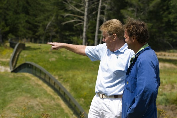 Wairakei golf + sanctuary owner, Gary Lane (left), and gamekeeper, Jeff Willis, inspect the Xcluder predator fence that runs around the perimeter of the golf course property