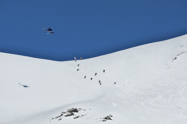 Snowboarders charge down the course of the VnC Downhill, the final event of the World Heli Challenge