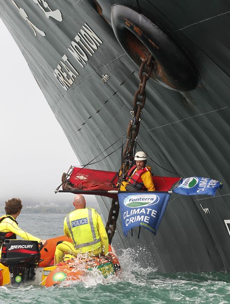 One of the five Greenpeace activists who boarded the ship has been removed, and placed under arrest, after five and a half hours on the anchor chain.