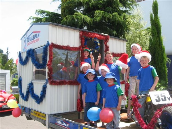 Children from Kaitoke School celebrate the news that their school will get a new bus shelter at the Wanganui Santa Parade