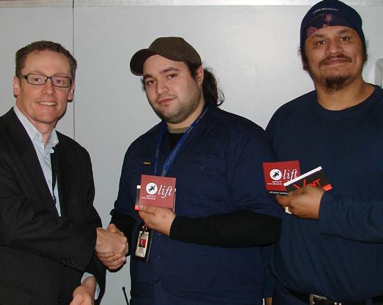 Martin Fryer, Auckland Airport's Sustainability Advisor, with Mitchell Davison (centre) and John Te Whaiti (right) as they receive their priority parking permits.
