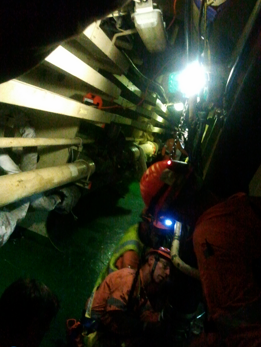 Salvors working inside Rena, as the vessel is without power they must bring in their own lighting.