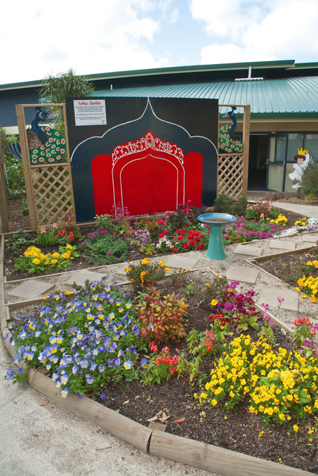 Indian garden, planted with brightly coloured flowers.