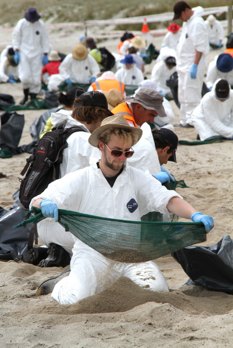 Benjamin Hoensch from Germany is part of the 100th volunteer cleanup operation held today on Papamoa Beach.
