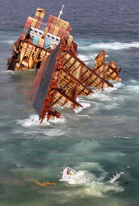 Shot of Rena with the stern section fallen off the reef while the bow remains in place. The bridge is almost totally submerged.