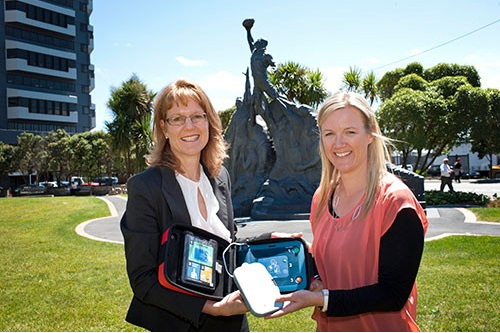 Carole Srhoy-Pullon (left) from St Johns shows the defibrillator to the Council's Events Manager.