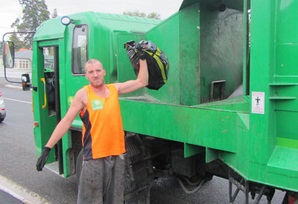 Council contractor Luke Brosnan tosses one of the Council black bags onto the Earthcare truck as it makes its rounds in Blenheim.