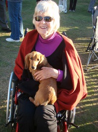 Lorraine Barsanti enjoys some puppy love from another of the other long haired dachshunds at the show.