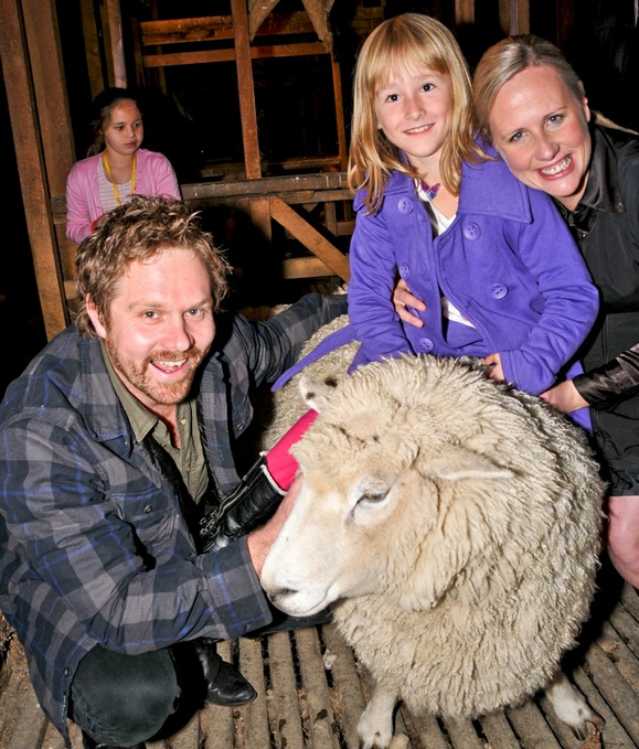  (L to R) Actor Will Hall, with Cure Kids ambassador Ashleigh Neal from Blenheim going for a ride on William the sheep, and  Josie Spillane from Cure Kids at Bendemeer Woolshed. Simone Lang from Christchurch is in the background.