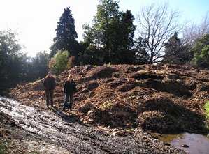 Council gardeners Julie Murphy and Kate Kidman show the scale of hte Council's composting area at Waterlea.