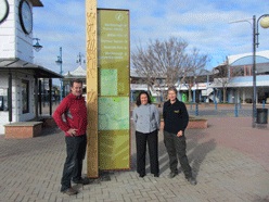 Councillor Terry Sloan and Reserves and Amenities staff Rosie Bartlett and Rachel Hutchinson check out the new sign in Market Place.
