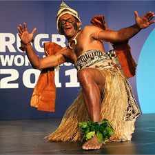 A traditional dancer welcomes members of the Fijian squad to Auckland.