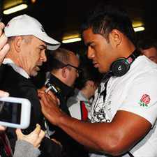 Manu Tuilagi arrives in Auckland with his England teammates.