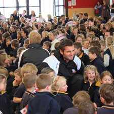 Georgia's number 8 Dimitri Basilaia is surrounded by school children in Wanaka