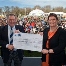 Ian McLauchlan hands over the cheque to deputy mayor Ngaire Button
