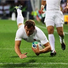 England's Mark Cueto dives across for the first of his tries against Romania