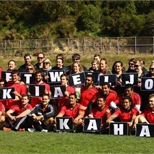 The All Blacks and NZRU staff hold up a get well message for Jonah Lomu