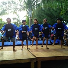 Young rugby players in the Cook Islands perform a haka for Jerome Kaino and the Webb Ellis Cup at the launch of the RWC legacy programme