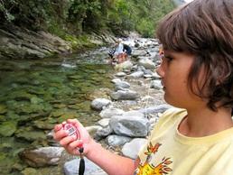 Niki Elliot looking at the water flow, water clarity and temperature.