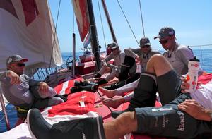 A light airs gathering on CAMPER's foredeck.