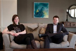 Artist and chef Kathryn Pender and Eichardt's Group General Manager Chris McIntosh relax at The Residence in front of Kathryn's painting 'Humboldt Falls, Fiordland'.