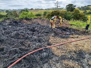Firefighters at the scene of the tyre burning incident near Kaiwaka last year.