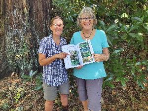 TRC's Leigh Honnor (left) and author Janet Hunt with a copy of the new booklet.