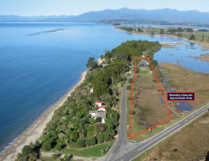 Lodge for sale beside tidal estuary and metres from stunning beach in the Nelson region of New Zealand. Excellent home and income opportunity!