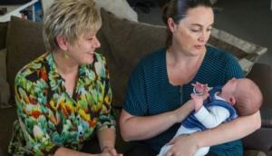 Midwife and College of Midwives advisor Jacqui Anderson with a new mum and baby