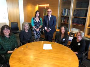 L to R Keriana Brooking (Dep Dir-Gen on behalf of MoH), Helen Mason (CE BoP signing on behalf of DHBs),  Hon Julie Anne Genter (Assoc Min of Health),  Hon David Clark (Min of Health),  Caroline Conroy (MERAS Co-leader: Midwifery) and Hilary Graham-Smith (Associate Professional Services Manager NZNO)
