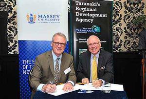 Steve Maharey and Stuart Trundle sign the partnership agreement 