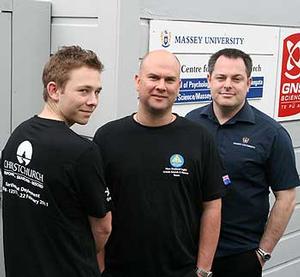 Todd Balogh (left) is hoping to take up postgraduate studies with the Joint Centre for Disaster Research. He models the T-shirt, with postgraduate diploma candidate Mark Mitchell (centre) and senior tutor Steve Glassey.