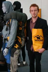 Nick Graham alongside a model showing how  his backyak design works.