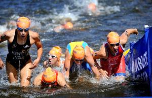 Andrea Hewitt (left) exits the swim on the first leg of the relay.