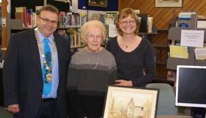  Mayor Ray Wallace with local identity Vera Ellen and sister-in-law Kate Ellen at the Petone Library with the Percy Mill painting.