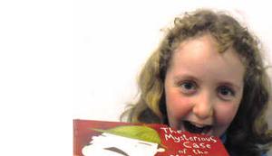Amy Broeders, 10, of Hutt Central, takes an imaginary bite into one of the many books about all things scrumptious that feature in the holiday reading programme.